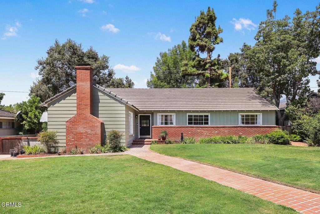 Front elevation of 4821 Daleridge Road with brick chimney and broad grassy lawn