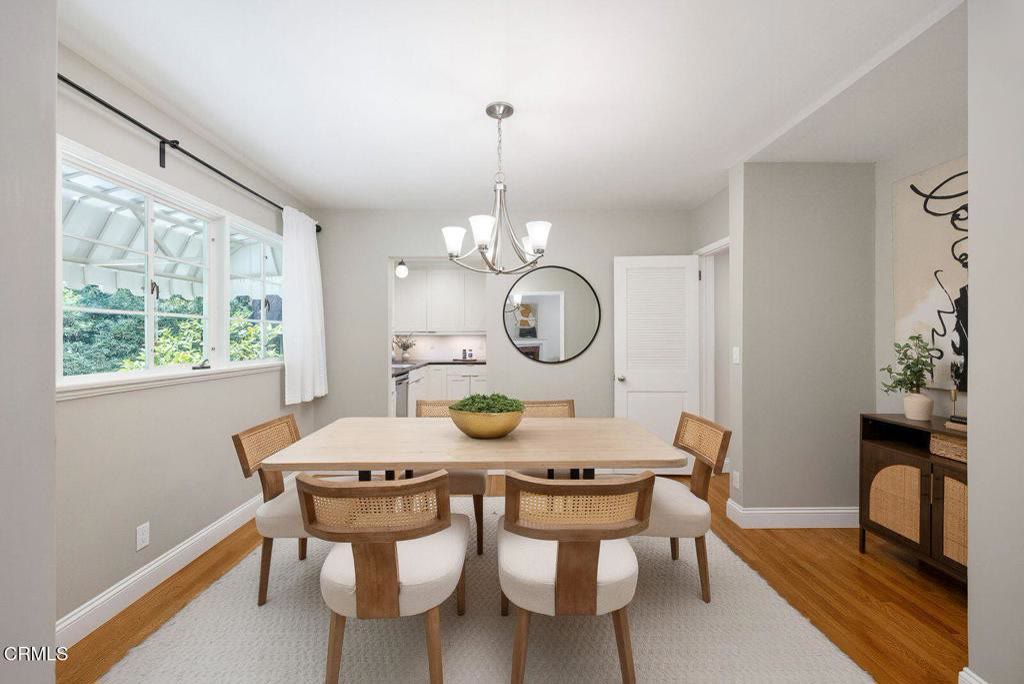 Dining area beneath a modern chandelier