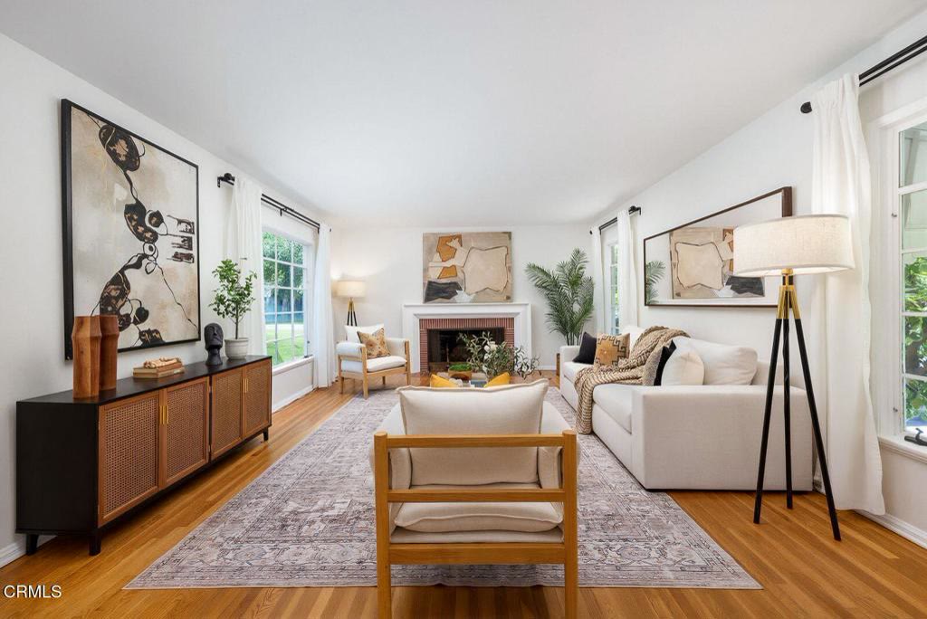 Formal living room with brick fireplace and original hardwood floors